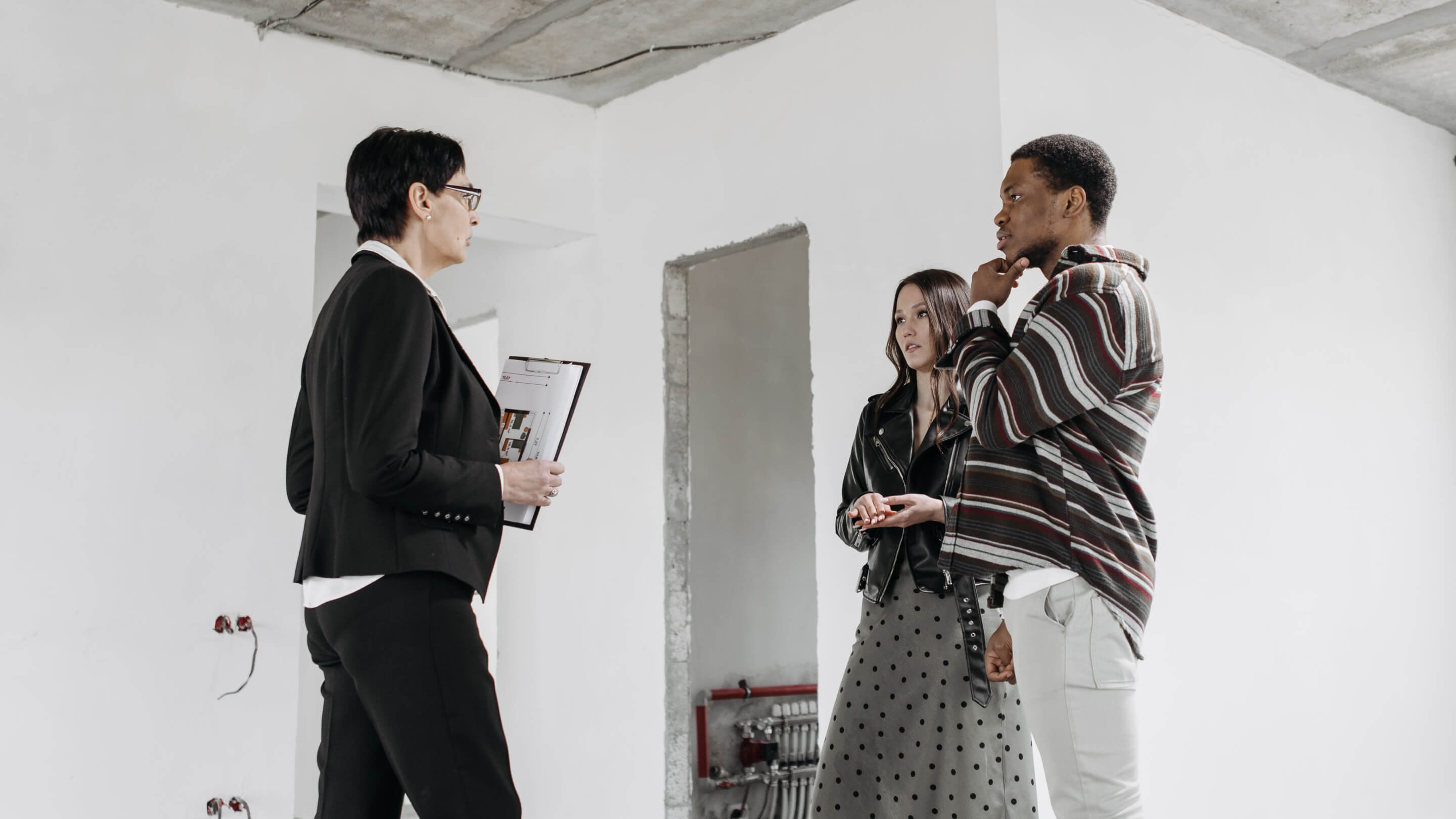 people inside a white painted room talking to each other